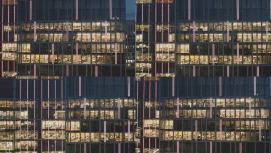 右边是在电脑前工作到很晚的办公室和商务人员在夜间摩天楼的窗户上拍摄的全景照片。高清在线视频素材下载