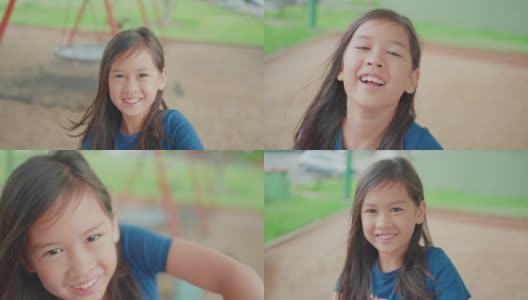 慢动作的混合亚洲女孩在游乐场旋转木马上，孩子在户外的乐趣，积极的健康概念高清在线视频素材下载