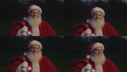 圣诞老人带着礼物袋的夜间特写镜头高清在线视频素材下载