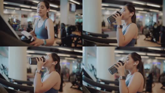 在健身房喝高蛋白奶昔的女运动员高清在线视频素材下载