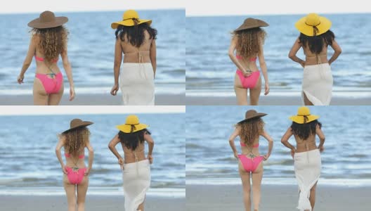 夏天，穿着比基尼的女人和朋友在海滩上散步。高清在线视频素材下载