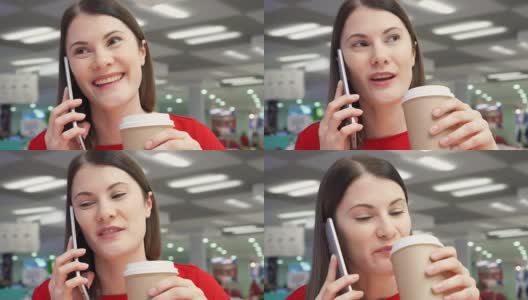 口渴的女孩在美食广场的快餐店用纸杯喝咖啡。打电话高清在线视频素材下载