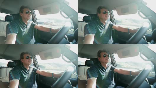 退休老人在高速公路上开车。老男人握着方向盘，表情坚定，表情丰富，他的脸在4K高清在线视频素材下载