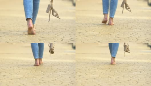 无忧无虑的女性赤脚踏着高跟鞋，舒适自由高清在线视频素材下载