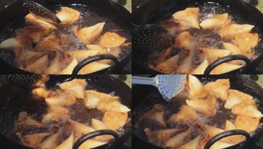 烹饪，油炸和指导北印度著名小吃旁遮普萨莫萨在滚烫的油高清在线视频素材下载