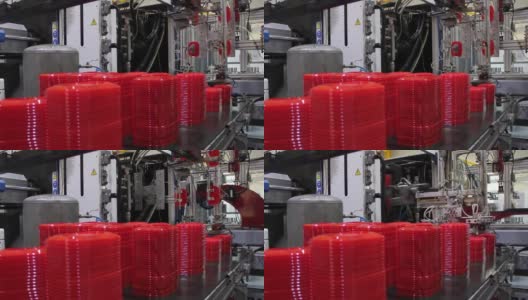工厂机器在传送带上放置红色塑料盖高清在线视频素材下载