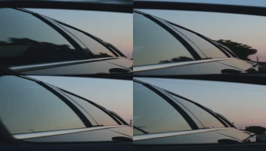 侧视镜反射出黄昏中行驶的汽车高清在线视频素材下载