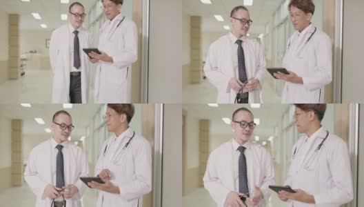两个身穿白大褂的男医生一边交谈，一边使用平板电脑，然后握手。在医疗和医疗技术方面的合作概念高清在线视频素材下载
