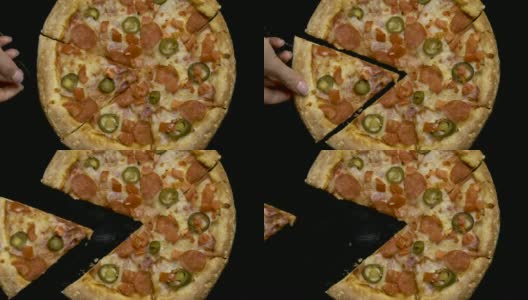 Hand在黑色背景下拿起一片披萨高清在线视频素材下载