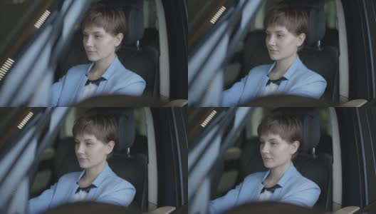 一个成功的可爱女孩坐在豪华轿车里的肖像。高清在线视频素材下载