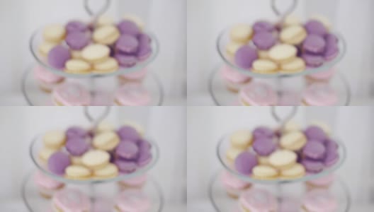 甜蜜的色彩斑斓的马卡龙。夹。五颜六色的杏仁饼干漂亮地装饰在花瓶上的糖果在白色的背景高清在线视频素材下载