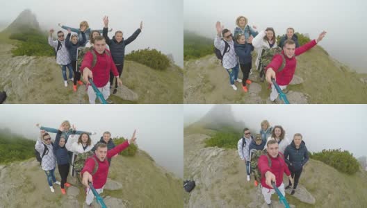 一群欢呼的青少年朋友站在山顶上视频自拍，分享他们的旅行冒险高清在线视频素材下载