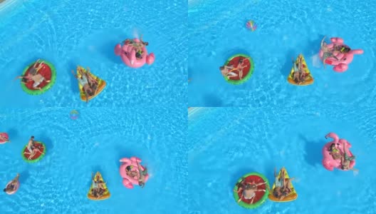 空中的朋友们在水池里打水仗，在彩色的浮子上泼水高清在线视频素材下载