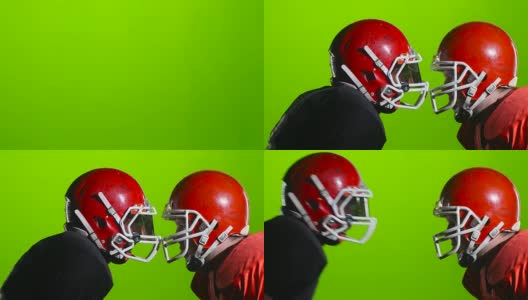 两名美式橄榄球运动员在赛场上戴着头盔。绿色的屏幕。近距离高清在线视频素材下载