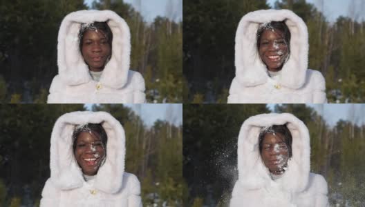 快乐的黑女孩在毛皮兜得到雪球在脸上微笑高清在线视频素材下载
