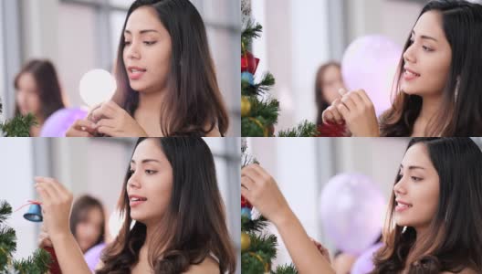 两位年轻女士喜欢在办公室装饰圣诞树高清在线视频素材下载