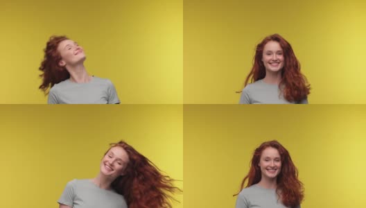 开朗的笑年轻的姜汁女子20岁在黄色背景摄影棚孤立的姿势。人们生活方式的概念。摇着头，飘飘的头发四处游荡，玩得开心。高清在线视频素材下载