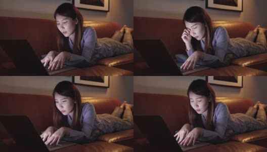 亚洲女性晚上使用笔记本电脑，她有眼睛刺激，蓝光对眼睛有害。高清在线视频素材下载