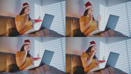 亚洲女人在圣诞节晚上视频聊天高清在线视频素材下载