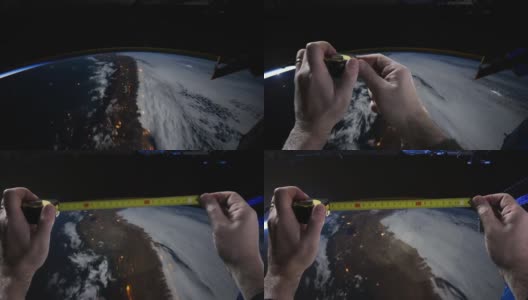 太空中的地球上空，手拿着黄色卷尺。这段视频的元素由美国宇航局提供。高清在线视频素材下载
