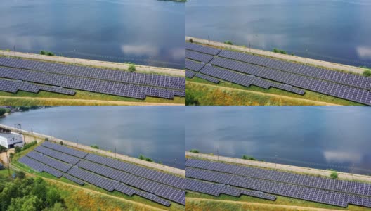 太阳能农场在美丽的蓝水背景。蓝色光伏太阳能电池板从太阳中产生清洁能源。鸟瞰图。高清在线视频素材下载