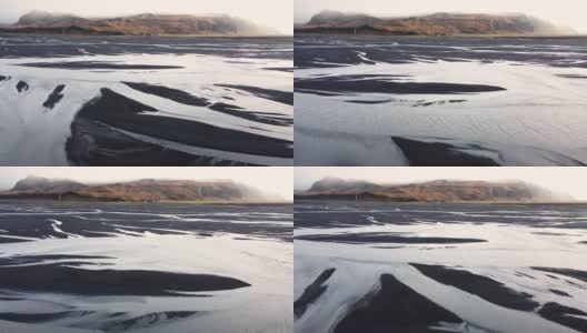 鸟瞰图，冰岛河流流入海洋的图案，不同寻常的美丽景观，冰岛的早春，干净的水和原始的自然高清在线视频素材下载