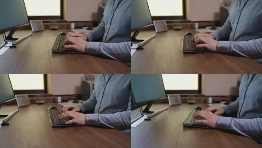 一个穿着蓝色衬衫的男人在键盘上打字。用文档编辑软件编写文档。木制的桌子。机动滑块录像。高清在线视频素材下载