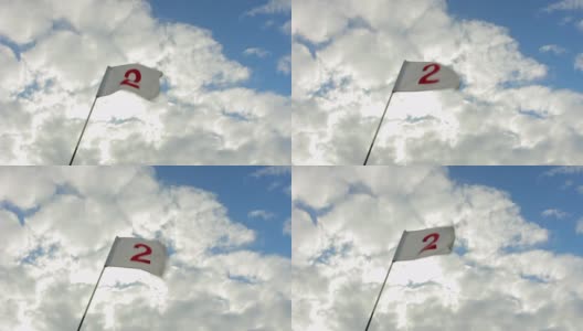 在晴朗多风的日子，明亮的多云背景上的高尔夫旗帜。高清在线视频素材下载