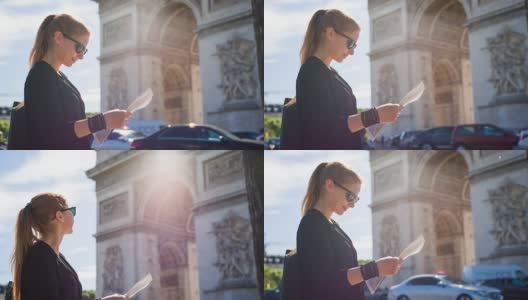 一位妇女站在著名的凯旋门前看巴黎地图高清在线视频素材下载