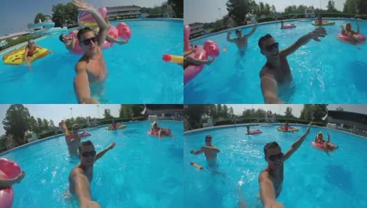自拍:有趣的家伙和快乐的朋友们在泳池里的彩水上打水高清在线视频素材下载