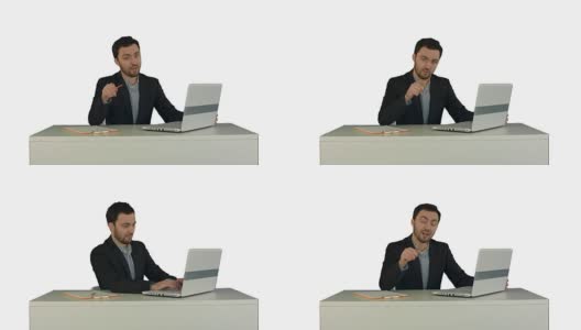 快乐的商人坐在办公室与笔记本电脑，说在摄像头上的白色背景孤立高清在线视频素材下载