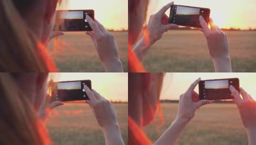 年轻的女人用手机拍日落的特写高清在线视频素材下载