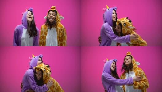 有趣的年轻女人穿着独角兽和长颈鹿睡衣，大笑，娱乐高清在线视频素材下载