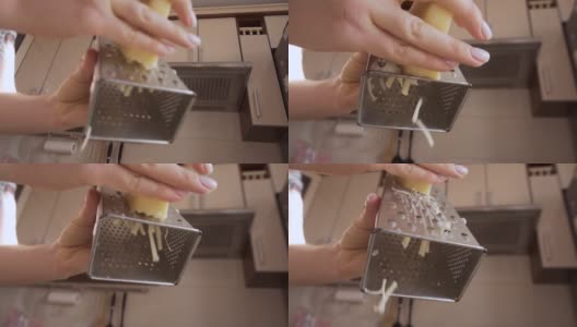 自制的奶酪卷。白干酪面包。用刨丝器把奶酪磨碎高清在线视频素材下载