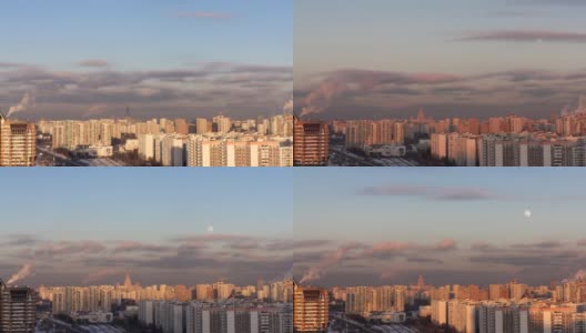 在寒冷的冬日阳光明媚的日子里，一轮满月冉冉升起在莫斯科城市上空。许多建筑物，被傍晚的太阳照明，蓝天和大量的烟雾从火电厂的管道。时间流逝。俯视城市高清在线视频素材下载
