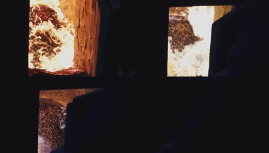 燃烧木屑颗粒是一种可再生资源，现代燃木炉在冬天为房屋供暖高清在线视频素材下载