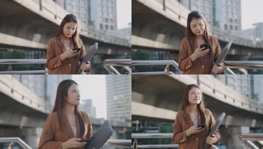 亚洲成功女商人在城市使用智能手机高清在线视频素材下载