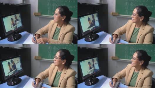老师看着学生做在线演示高清在线视频素材下载