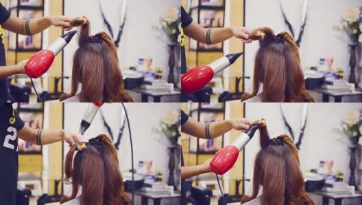 长头发的女人在美容院吹风机高清在线视频素材下载