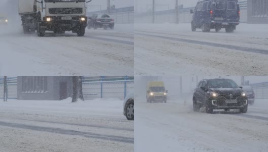 城市遭遇暴风雪天气。交通在城市中行驶，在暴风雪期间。高清在线视频素材下载