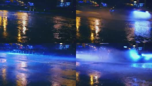 在城市的夜间道路上，汽车开进大水坑，车轮下溅起水坑高清在线视频素材下载