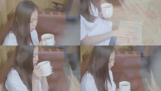 亚洲年轻人在喝咖啡休息时间用笔记本电脑高清在线视频素材下载