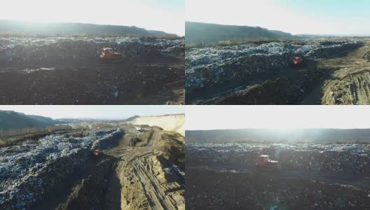 航拍:推土机在一个巨大的垃圾场里铲垃圾高清在线视频素材下载