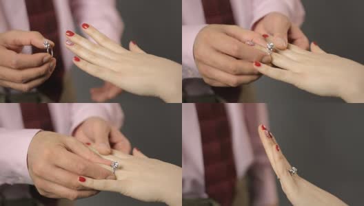 男人把漂亮的银戒指戴在女人手上，求婚，订婚高清在线视频素材下载