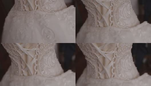 华丽的婚纱与紧身衣和亮片挂在复古人体模型的后视图。高清在线视频素材下载