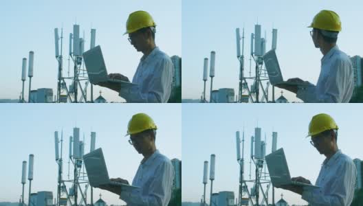 工程师使用笔记本电脑检查5G电信基站塔高清在线视频素材下载