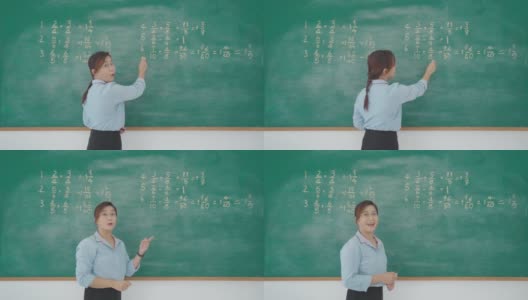 亚洲小学教师导师在黑板上讲解数学，在教室里看着摄像机，通过网络学习直播视频会议进行远程学校课堂在线教学。高清在线视频素材下载