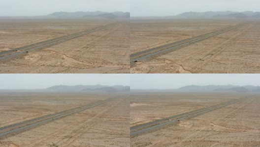 汽车在戈壁沙漠上行驶的鸟瞰图高清在线视频素材下载