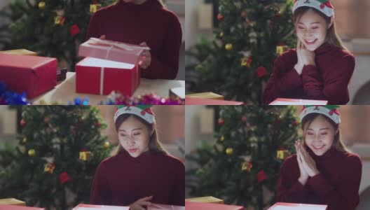 年轻的亚洲少女打开圣诞礼盒高清在线视频素材下载