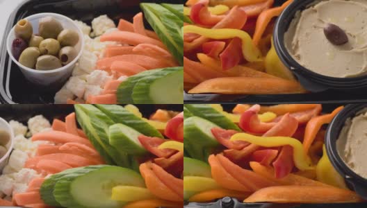 橄榄，羊乳酪，黄瓜片，甜椒和鹰嘴豆泥开胃菜高清在线视频素材下载